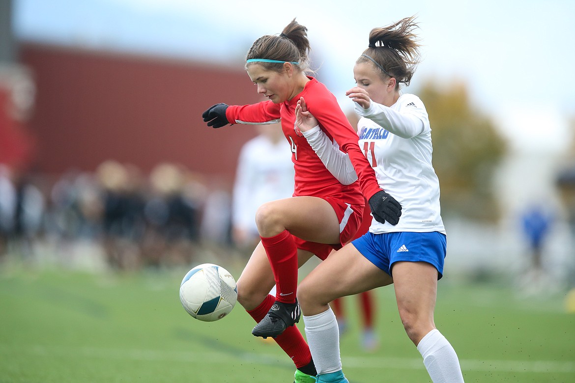 Madeline Mitchell fends off a Pocatello player in Saturday consolation championship at the Idaho 4A State Soccer Tournament.