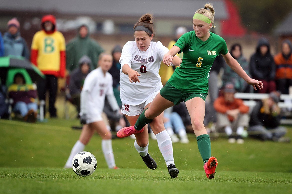 Whitefish's Isabelle Cooke keeps the ball away from Hamilton's Lexi Brenneman during action in the State A semifinal in Whitefish on Saturday, Oct 22. (Jeremy Weber/Daily Inter Lake)