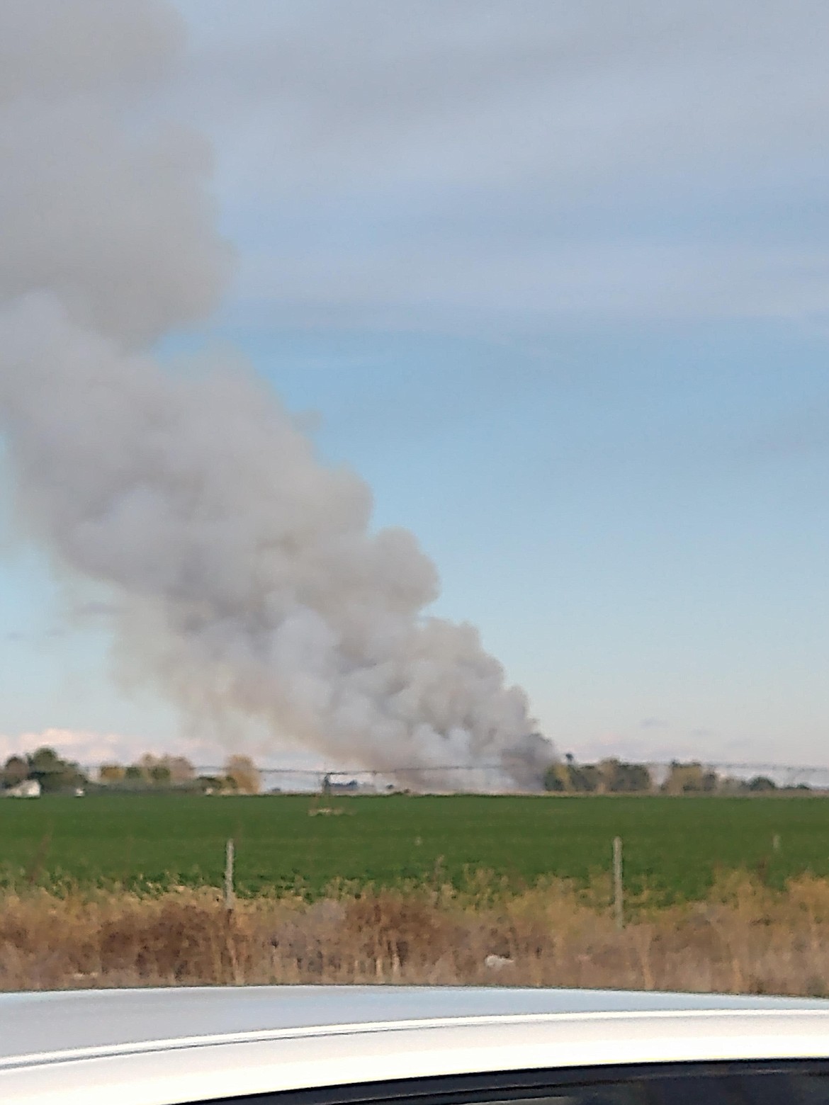 Smoke Billows from the Wilbur-Ellis fertilizer and blending facility southeast of Moses Lake on Sunday. Firefighting crews eventually stopped adding water to the blaze after it became unsalvageable and concern for washing excessive amounts of fertilizer and chemicals into the ground became the larger concern.