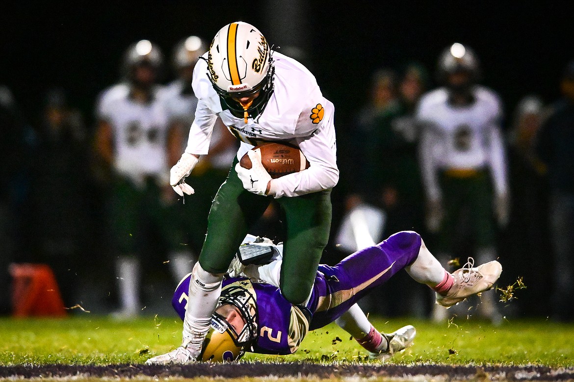 Whitefish wide receiver Mason Kelch (10) is brought down by Polson's Colter Wilson (2) on a reception in the second quarter at Polson High School on Friday, Oct. 21. (Casey Kreider/Daily Inter Lake)