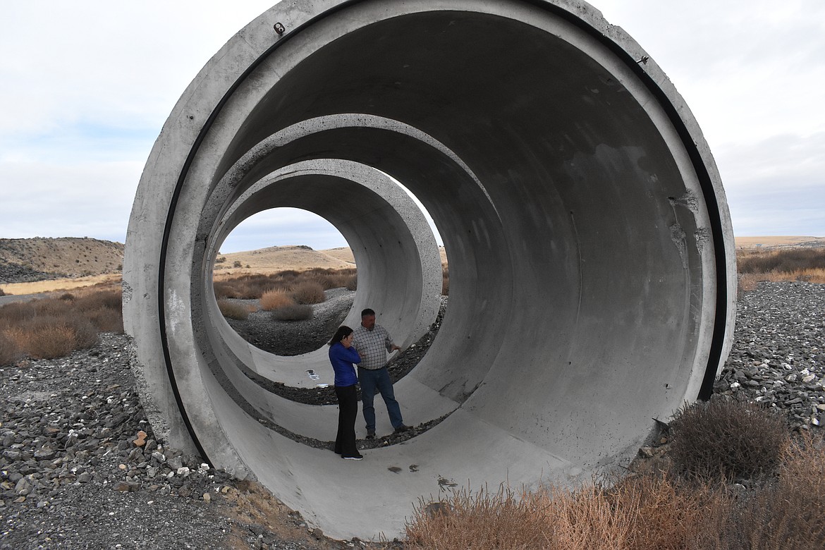 Senator Maria Cantwell, left, is shown one of the siphon barrels that were used to bring water to southeast Basin farmland by East Columbia Basin Irrigation District Secretary-Manager Craig Simpson, right.