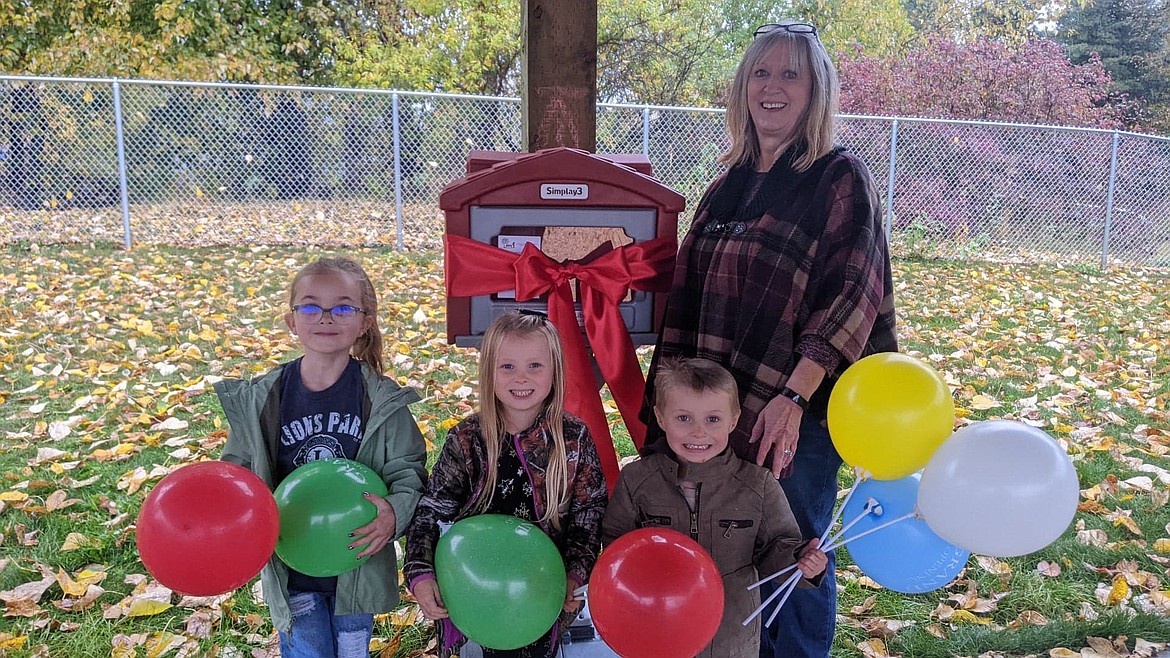 Osburn Library Director Jamee Sperry unveils the new Free Little Library at the Lion's Park.