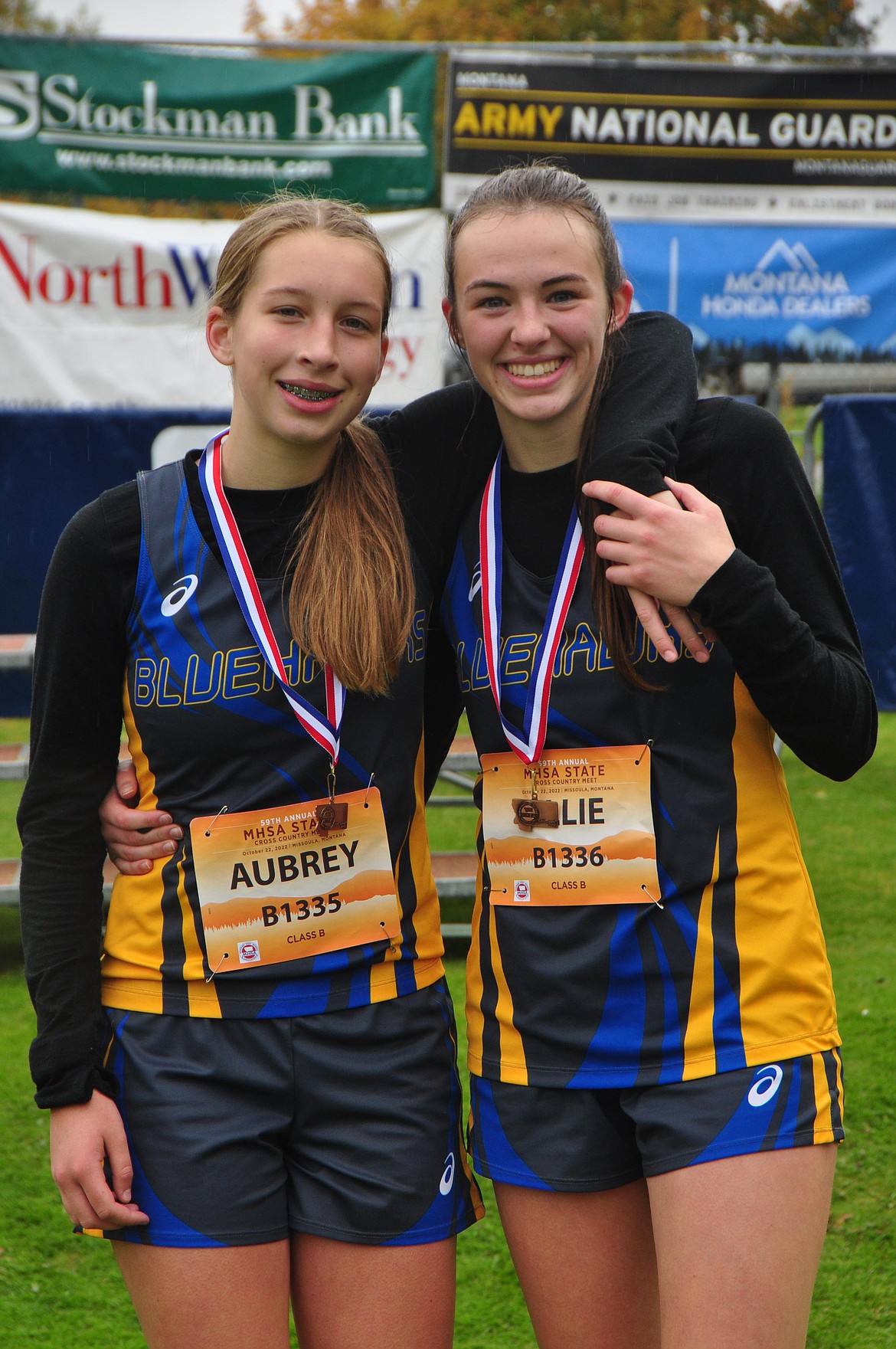 Thompson Falls' Baxter sisters, Aubrey (left) and Ellie (right) display their top-10 finisher medals at the State Class B/C cross country championship race in Missoula. (Photo by coach Sarah Naegeli)