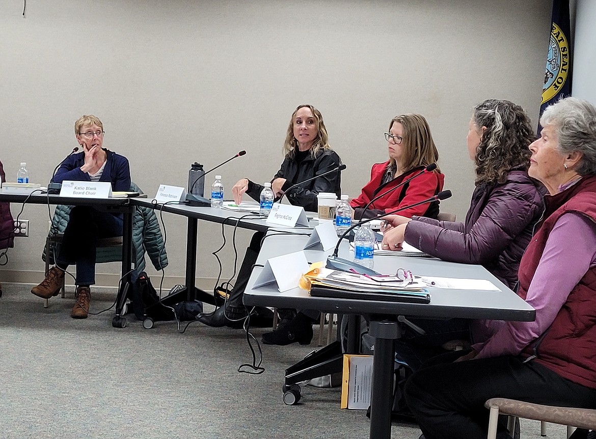 Community Library Network Trustee Vanessa Robinson, center, discusses policy language with fellow board members Monday during a special meeting held in the Post Falls Library.