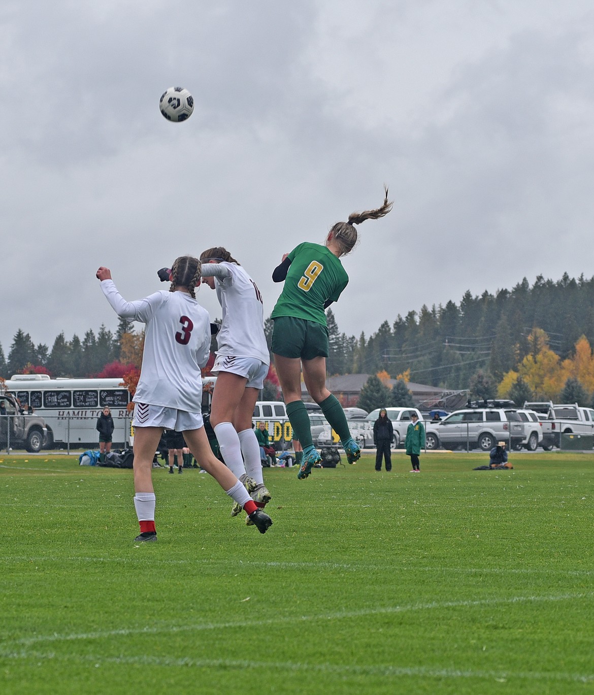 Whitefish forward Delaney Smith soars over two Hamilton player for a header in the semifinal game at Smith Fields Saturday. (Julie Engler/Whitefish Pilot)
