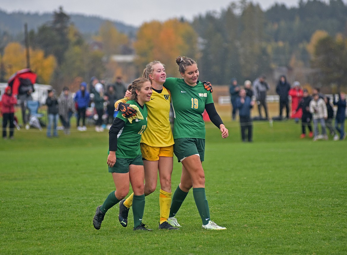 Bulldog soccer players Katie Benkelman, Norah Schmidt and Rya Hirsch walk off the field together after their win on Saturday against Hamilton in the semifinal game. (Julie Engler/Whitefish Pilot)