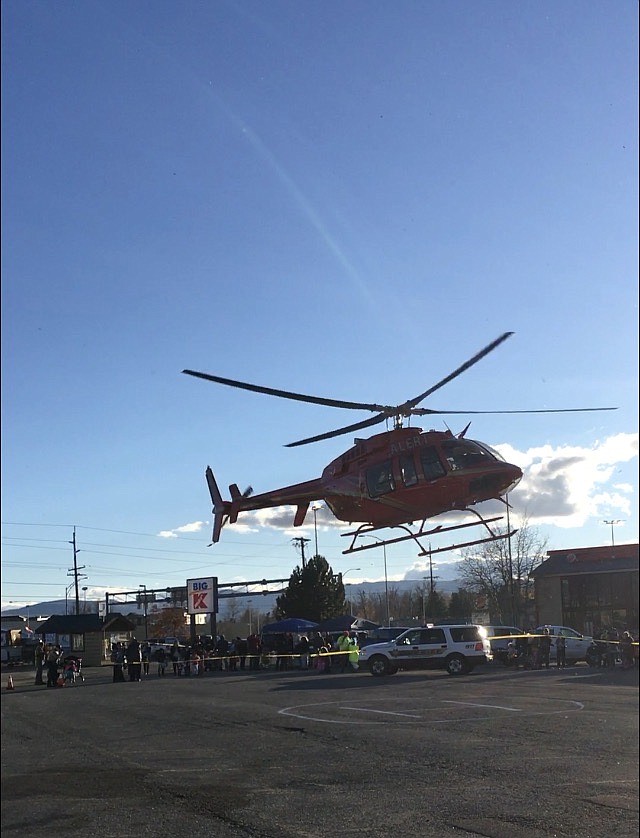 A crowd gathers as the A.L.E.R.T. helicopter arrives as part of the static display of first responders and law enforcement for the Flathead County Sheriff's Posse and Evergreen Chamber of Commerce's Halloween Trunk or Treat event in the former Kmart parking lot. (photo provided)