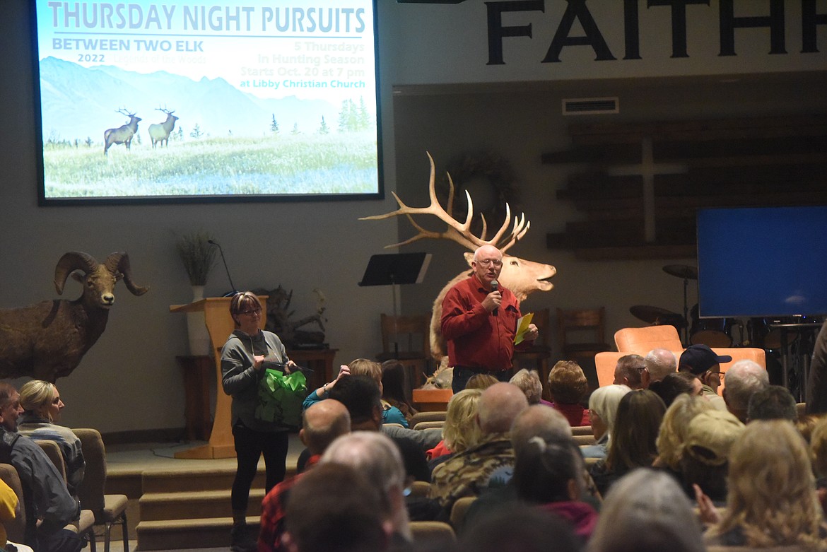 Libby Christian Church Associate Minister Dean Byrns announces raffle winners at the Oct. 22 Thursday Night Pursuits. (Scott Shindledecker/The Western News)