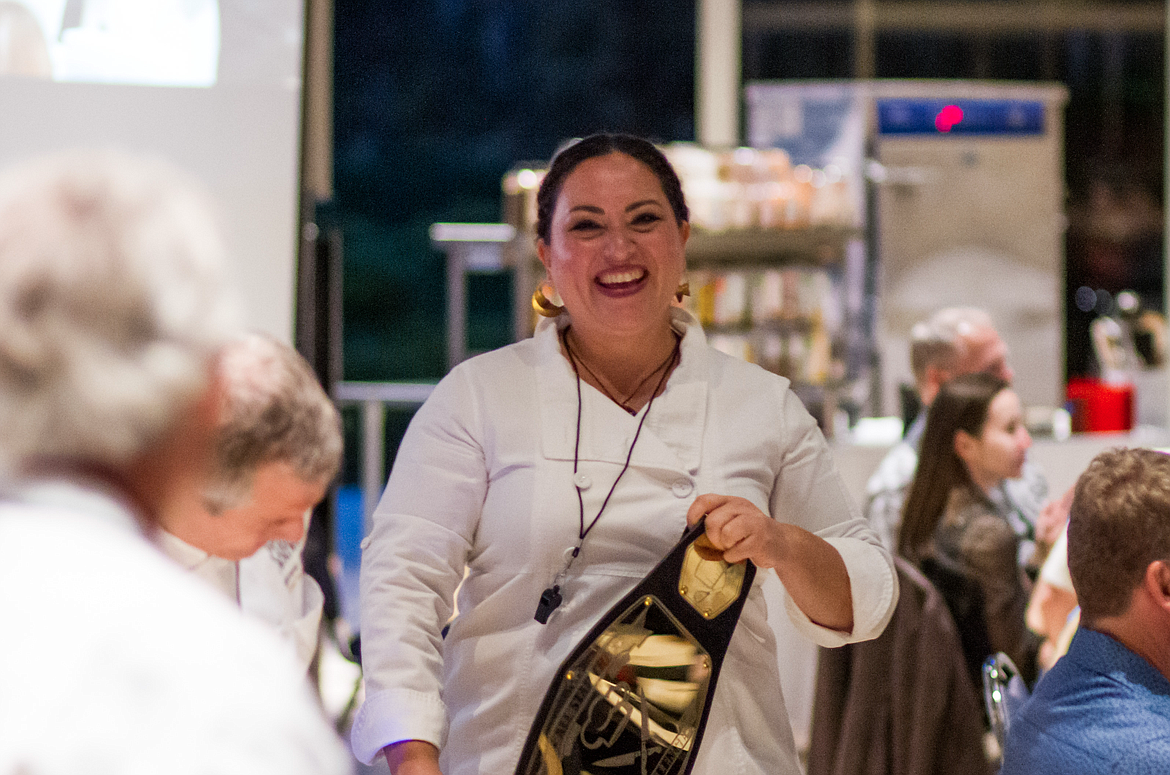 Cafe Carambola chef Colomba Aguilar, winner of last year's CDAIDE Chef Challenge, prepares to pass on the winning chef belt during the 2022 event on Oct. 13.