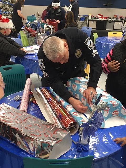 Quincy Police Department/courtesy photo
Quincy Police officers and staff handled the present wrapping at a previous Cops & Kids distribution. The QPD is collecting donations and sponsoring a fundraising raffle for Cops & Kids 2022.