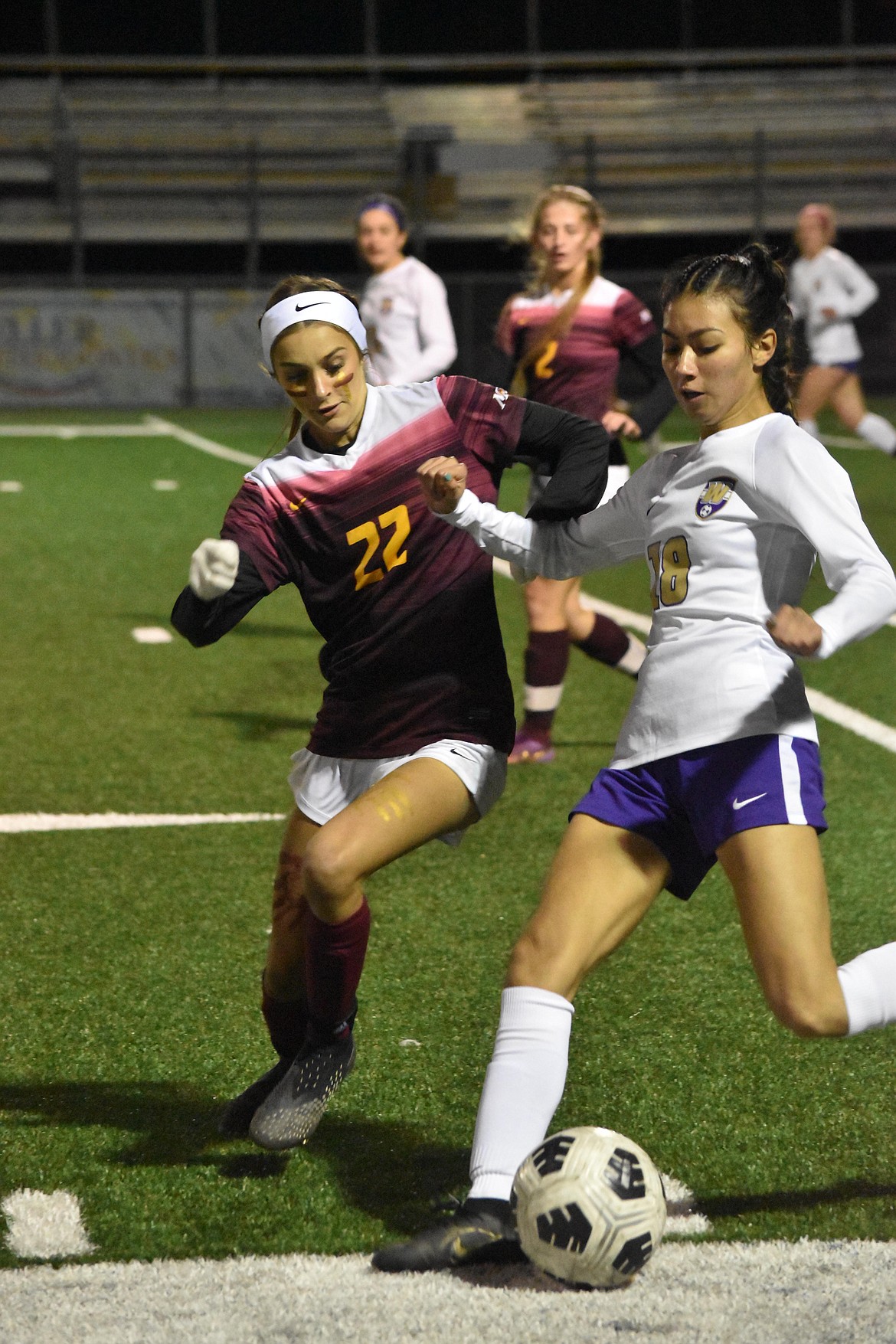 Senior Julia Lundberg (22) swoops in to attempt to take the ball from Wenatchee’s Natalie Zacarias.