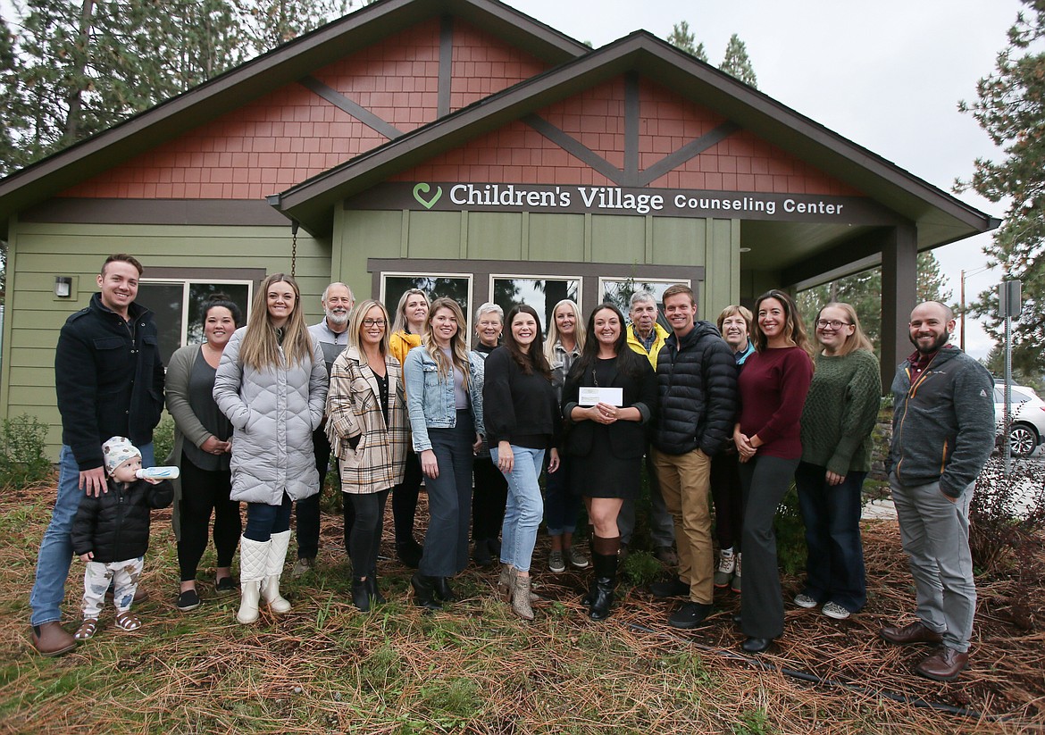 Silverwood Theme Park donated $100,000 to Children's Village on Tuesday during a gathering of park representatives and Children's Village employees and board members. Front row, from left: Stephanie Sampson, Griffen Turnbull, Nicole Jacklin, Wendi Yellin, Vanessa Moos, Jordan carter and Rosa Mettler. Back row, from left: Luke Yellin and baby son Ozzi, Emily Aizawa, Greg Orlando, Delilah Ebberts, Elaine Kingston, Toni Capaul, Tom Rau, MJ Nabors, Ashlee Aurora and Greg Lee.