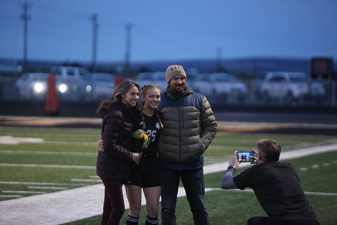 Royal senior Sam Fitzhugh poses for a photo being taken by head coach Jens Jensen before the Knights’ match against La Salle. Fitzhugh scored a goal in the win.