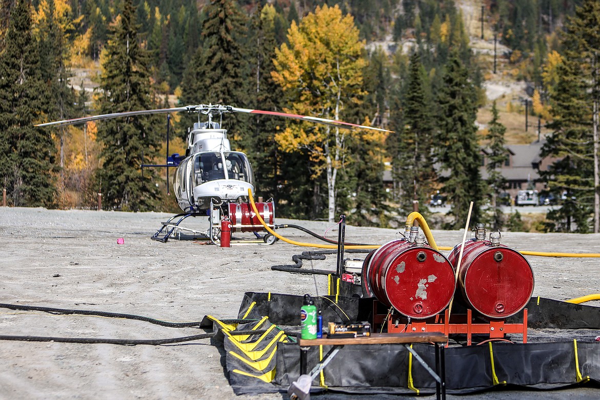 Flash 21, a fire ignition gel, is loaded on to a Forest Service helicopter for a prescribed burn on Big Mountain. (JP Edge photo)