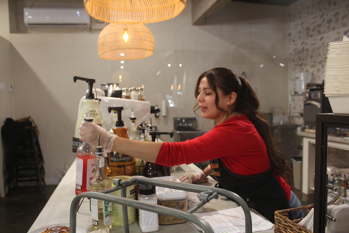 Desert Rose Cafe barista Bianca Solis mixes a latte. Coffee drinks at Desert Rose are made from beans roasted locally.