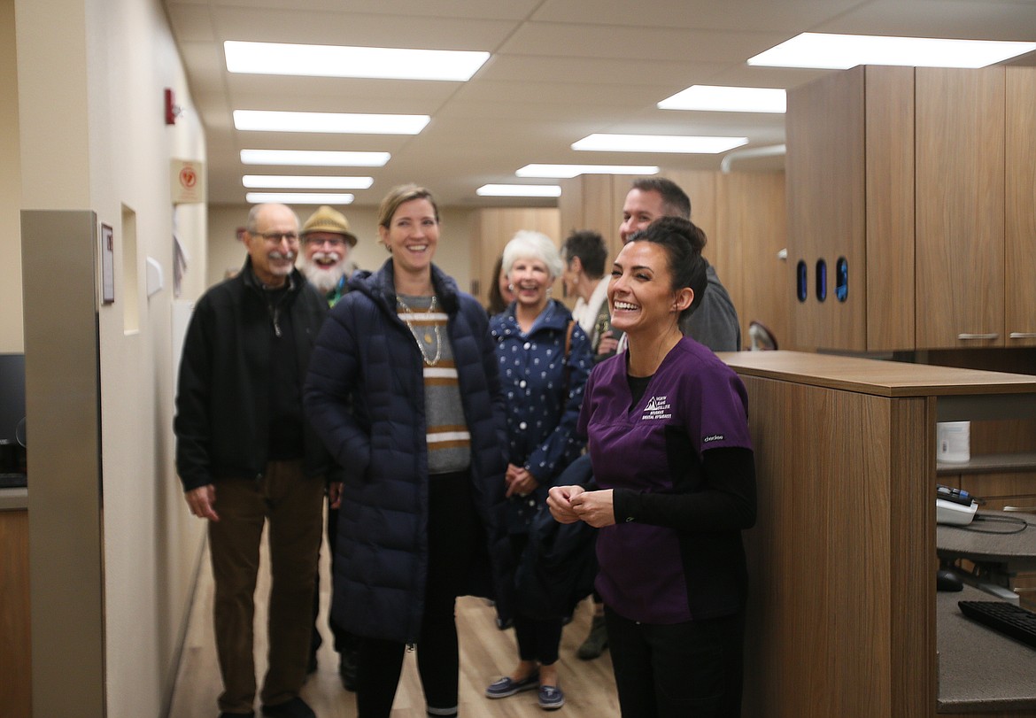 North Idaho College dental hygiene student Jennifer Joseph and a tour group share a laugh in the new dental clinic on campus during an open house Thursday.