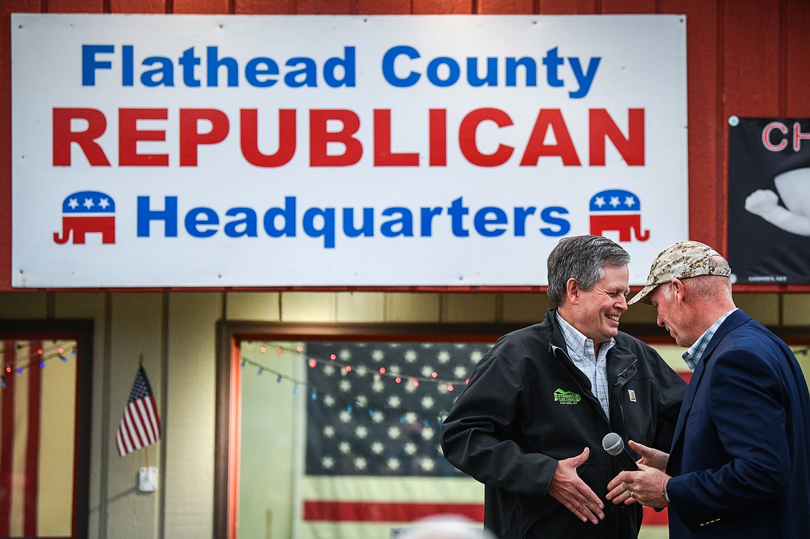 Senator Steve Daines passes the microphone to Gov. Greg Gianforte during a grassroots rally hosted by Ryan Zinke, Republican candidate for Montana's western district congressional seat, at the Flathead County Republican Headquarters on West Reserve Drive in Kalispell on Friday, Oct. 28. (Casey Kreider/Daily Inter Lake)