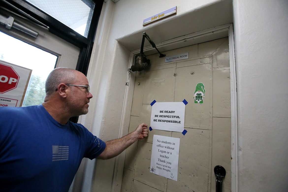 Mountain View Principal Paul Uzzi knocks on the door to the school's boiler room, said to be where resident ghost Evelyn dwells. “That’s steel,” he said. “It’s solid to keep spirits in.”