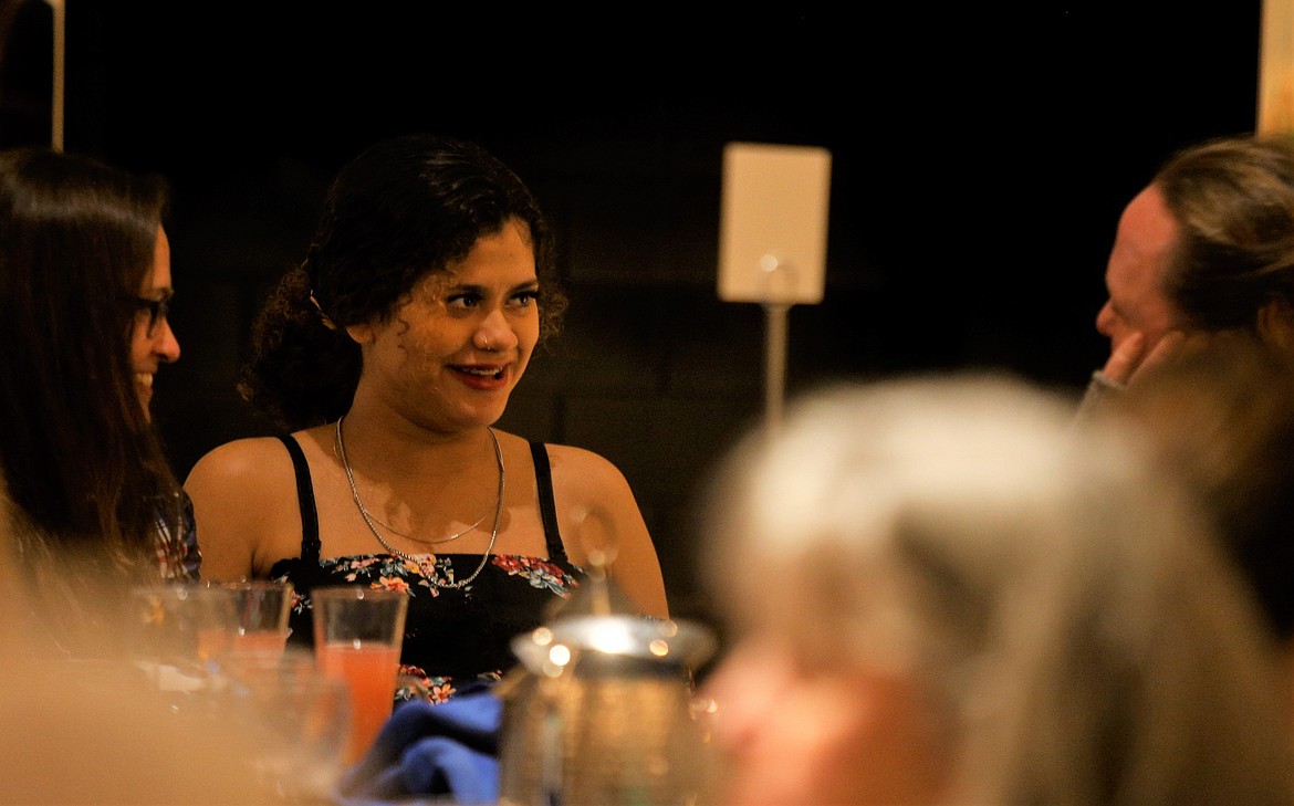 Diana Chavez talks with her adoptive mother Cassie Chavez, right, and adoption worker, Terassa Ruiz, left, during "CASA Uncorked" annual fundraiser at the Hagadone Events Center on Thursday.