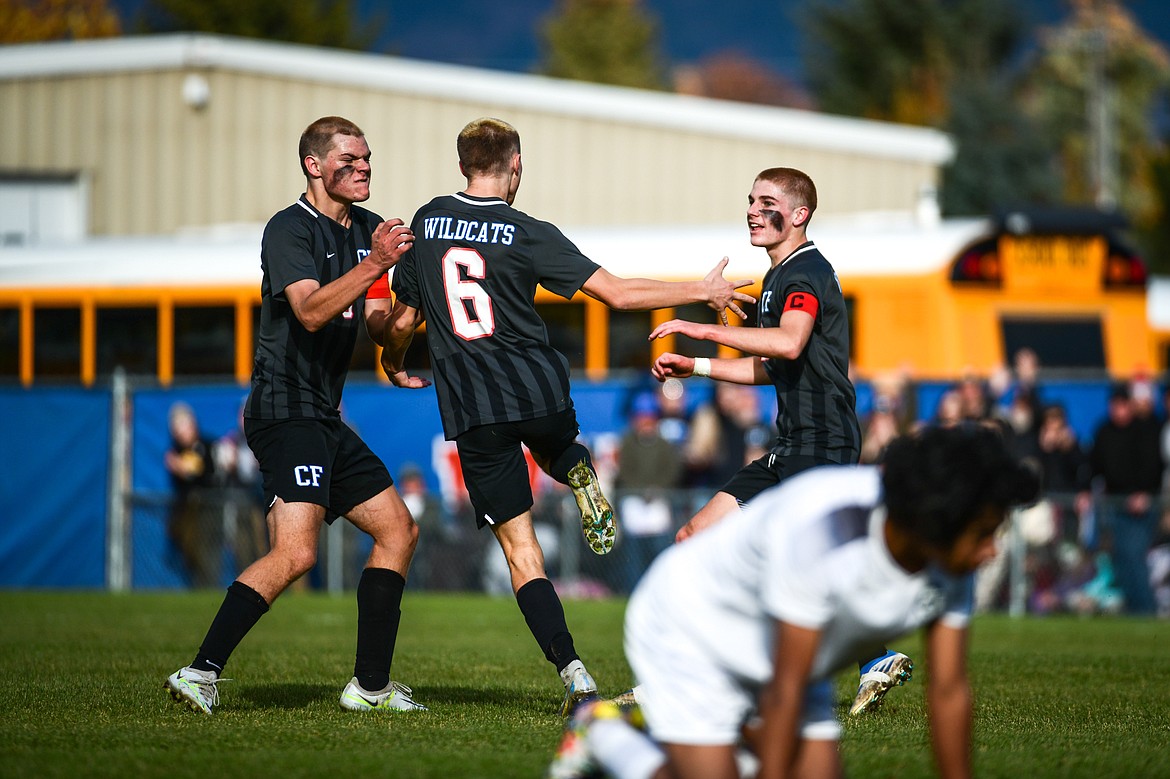 Columbia Falls' Nico Lang (8), Dale Blickhan (6) and Walt Nichols (2) celebrate after Blickhan's goal in the first half of the State A Championship game against Livingston at Flip Darling Memorial Field in Columbia Falls on Saturday, Oct. 29. (Casey Kreider/Daily Inter Lake)