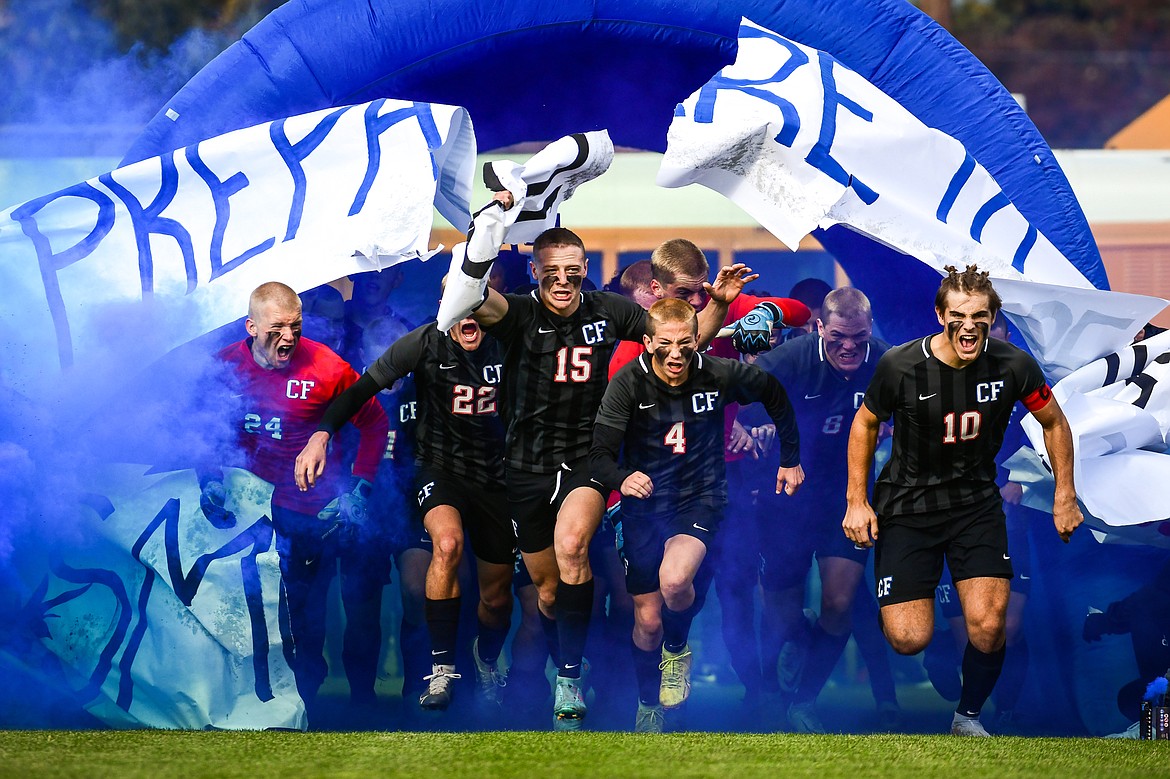 The Columbia Falls Wildcats run through their inflatable tunnel before the State A Championship game against Livingston at Flip Darling Memorial Field in Columbia Falls on Saturday, Oct. 29. (Casey Kreider/Daily Inter Lake)
