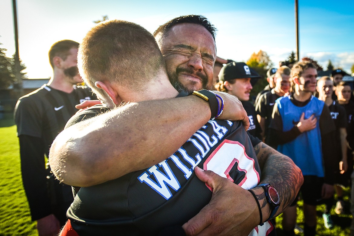 Columbia Falls head coach O'Brien Byrd hugs senior midfielder Walt Nichols (2) after the Wildcats 5-2 win over Livingston in the State A championship at Flip Darling Memorial Field in Columbia Falls on Saturday, Oct. 29. (Casey Kreider/Daily Inter Lake)