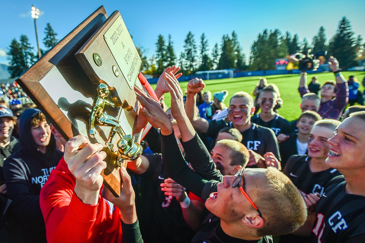 Columbia Falls celebrates with the state championship trophy after their 5-2 win over Livingston at Flip Darling Memorial Field in Columbia Falls on Saturday, Oct. 29. (Casey Kreider/Daily Inter Lake)