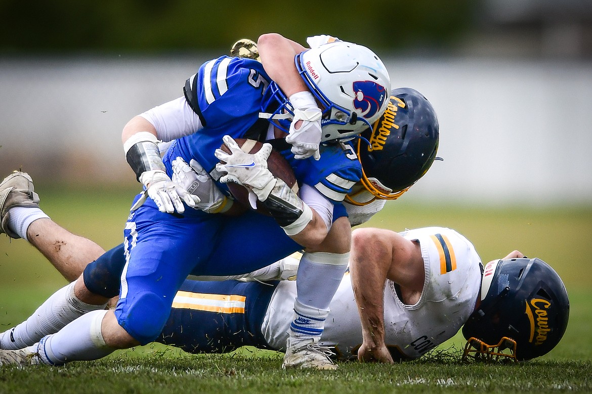 Columbia Falls wide receiver Mark Robison (5) is brought down by Miles City defenders in the second quarter at Satterthwaite Field on Saturday, Oct. 29. (Casey Kreider/Daily Inter Lake)