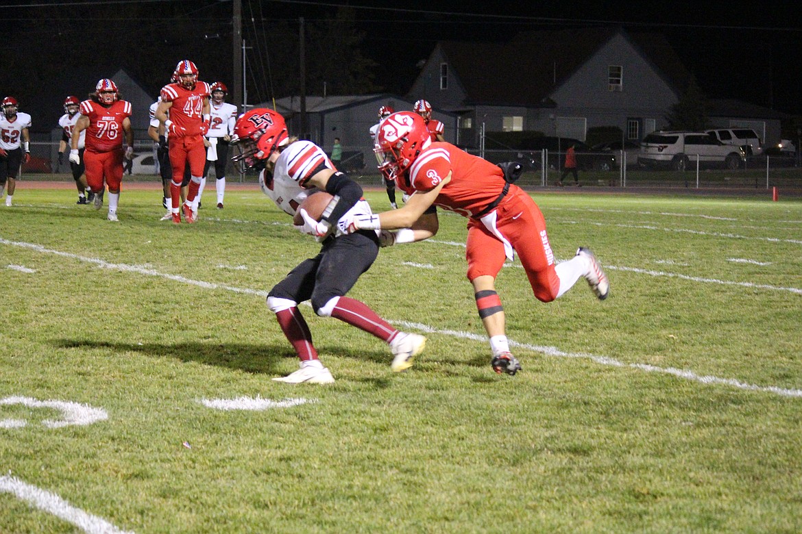 Othello’s Ezra Gonzalez (3) stops East Valley of Yakima’s Christian Flores (24) during the Huskies’ 35-10 win on Senior Night Friday.