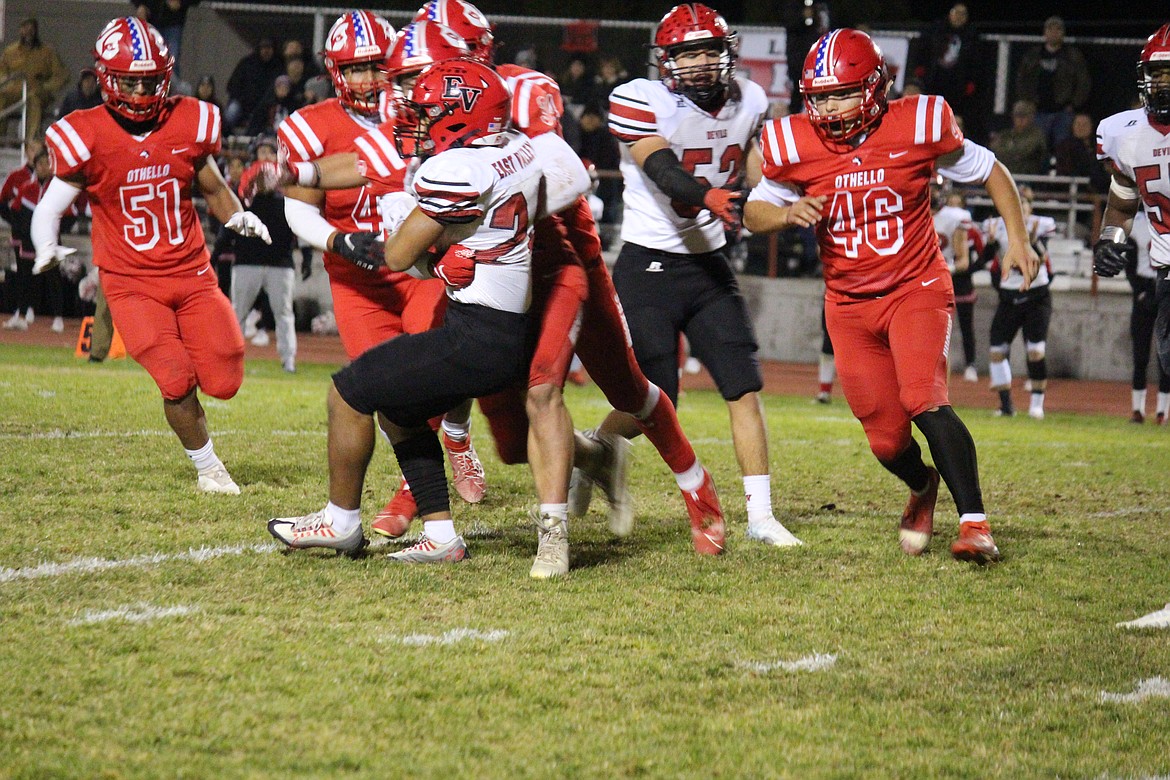 The Othello defense converges on East Valley of Yakima’s Christian Flores (24).