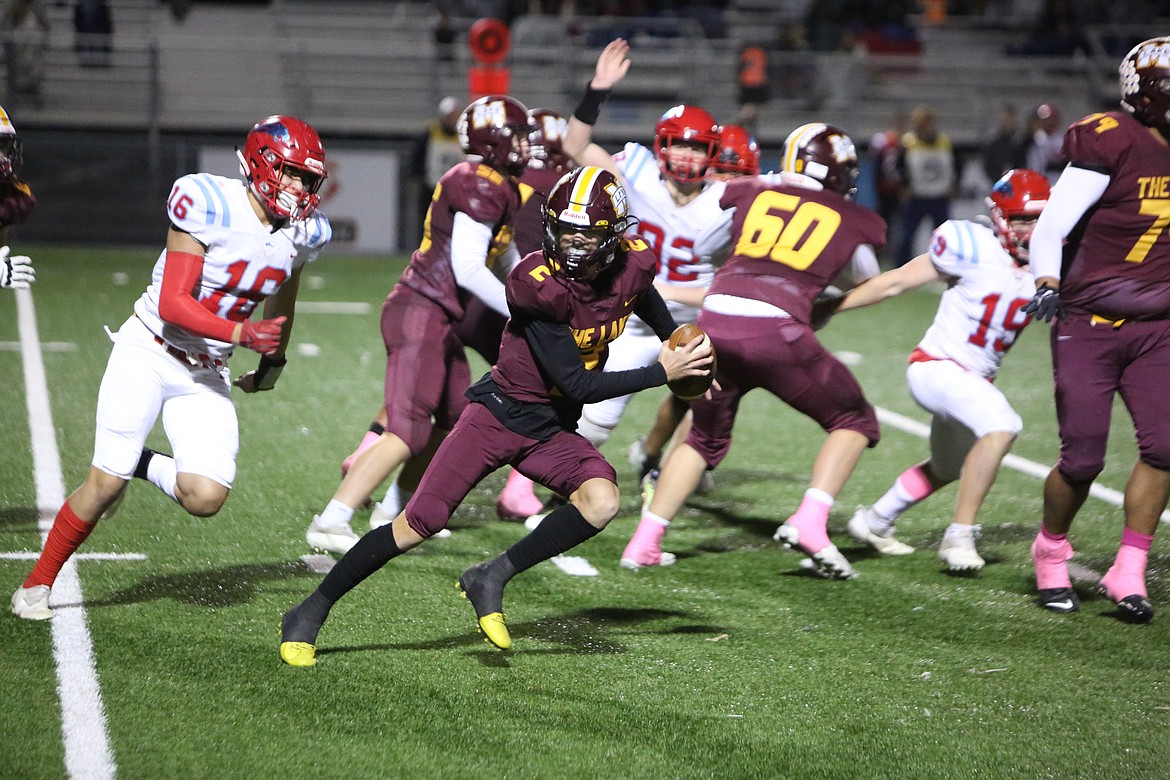 Moses Lake quarterback Brady Jay (2) evades pressure in the pocket and scampers for a 13-yard gain.