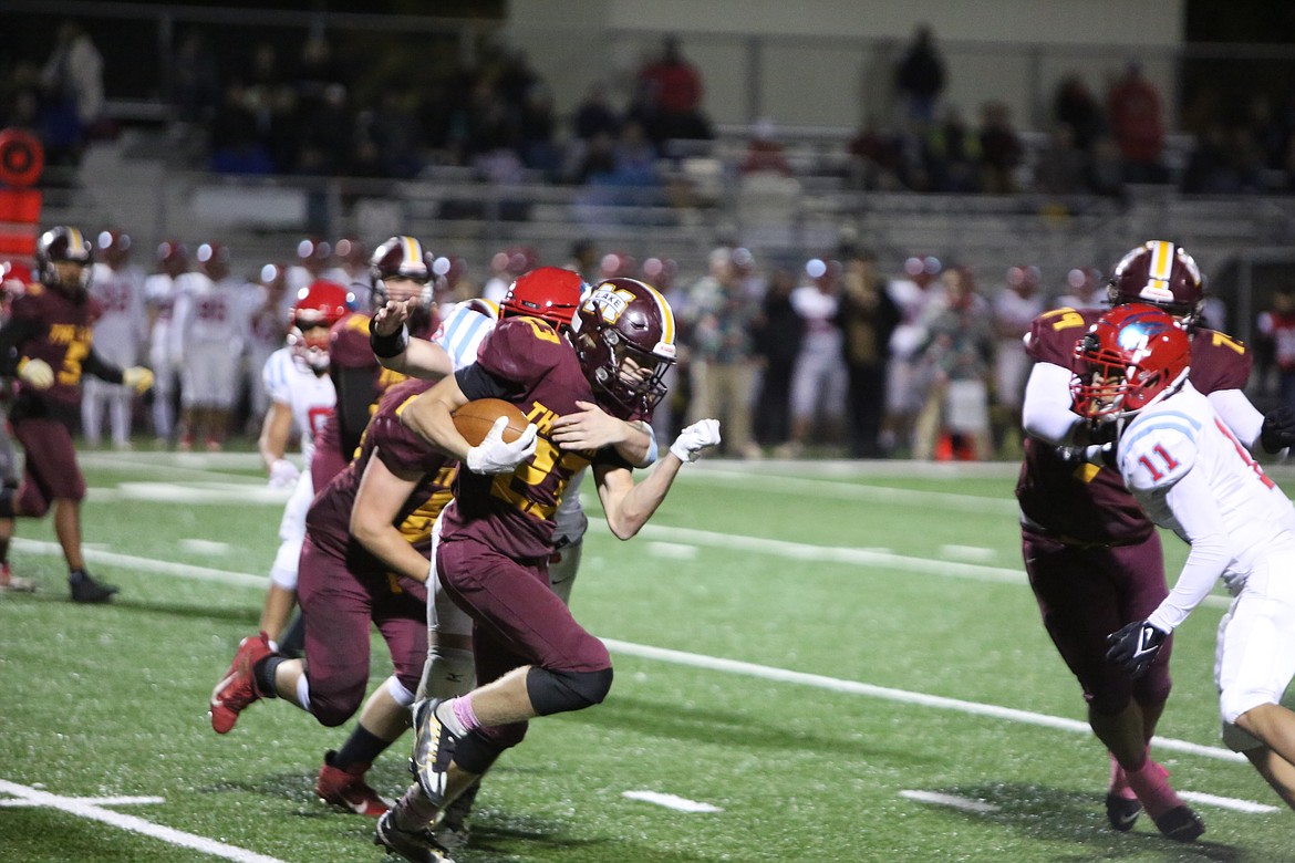 Maverick running back Maddox Gwinn (23) fights for extra yards, running through Eastmont tacklers.