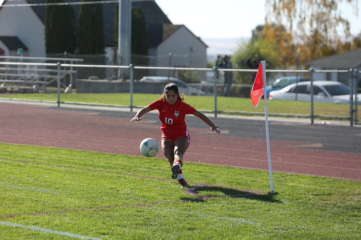 Junior Stephanie Gonzalez takes a corner kick in the second half for the Huskies.