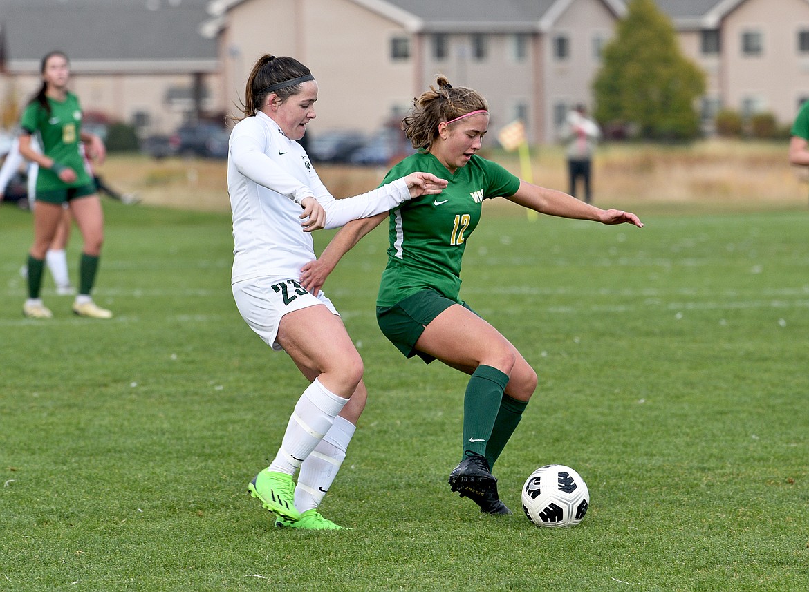 Bulldog senior Katie Benkelman works to keep the ball away from a Billings Central defender during second half of the State A final on Saturday in Whitefish. (Whitney England/Whitefish Pilot)