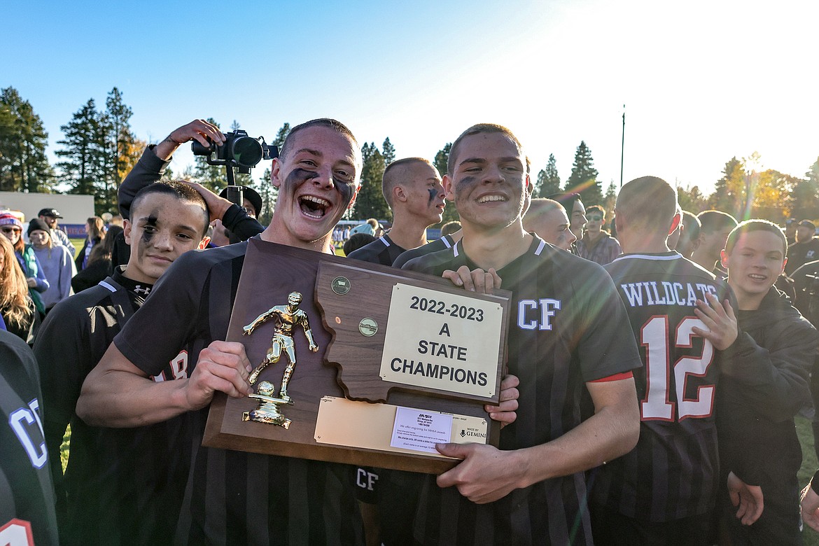 Seniors Adam Schrader and Nico Lang hold the State A title trophy after the victory over Livingston. (JP Edge photo)