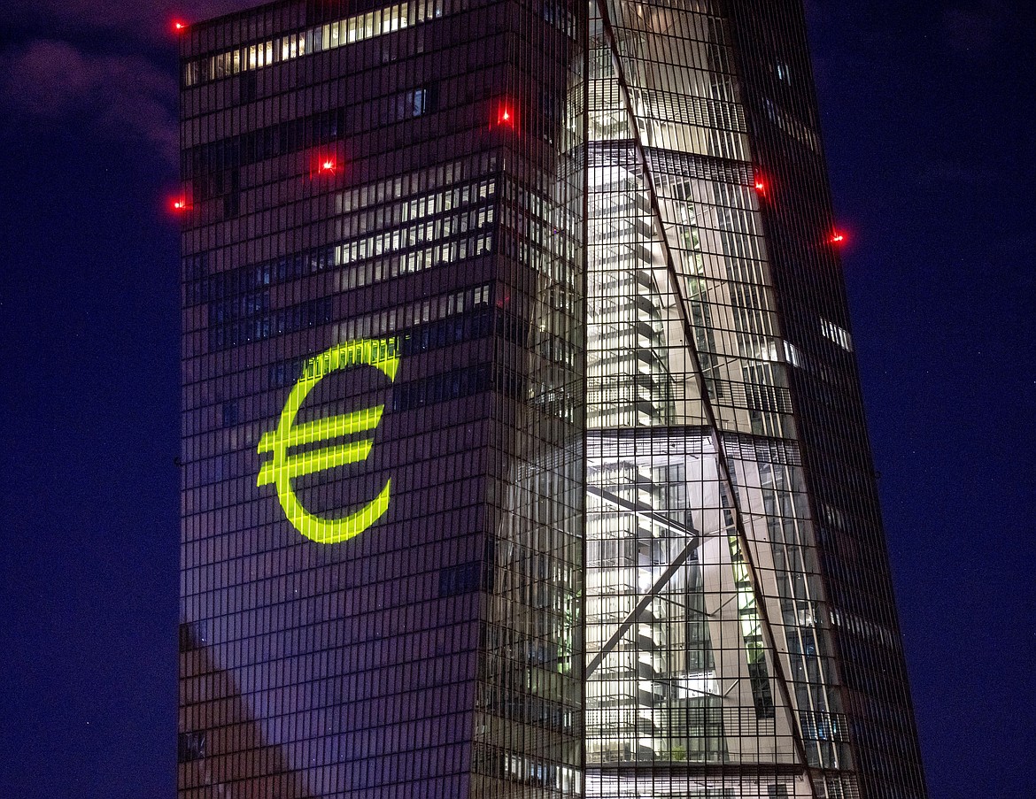 FILE - A light installation is projected onto the building of the European Central Bank during a rehearsal in Frankfurt, Germany, Dec. 30, 2021. Inflation hit a new record in the 19 countries that use the euro currency, fueled by out-of-control prices for natural gas and electricity due to the war in Ukraine, the European Union statistics agency Eurostat reported Monday, Oct. 31, 2022. (AP Photo/Michael Probst, File)