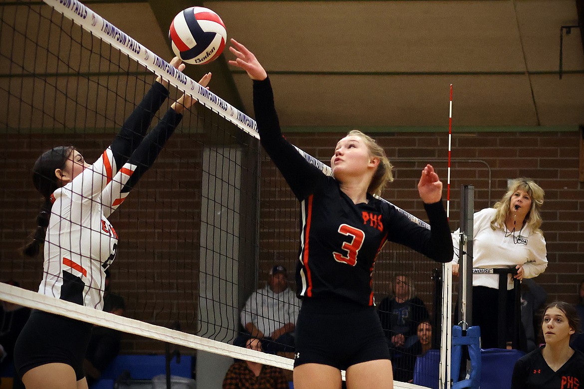 Plains player Piper Bergstrom pushes the ball past Eureka's Katelyn Singer during action in the opening round of the 7B District Volleyball Tournament in Thompson Falls Friday. (Jeremy Weber/Daily Inter Lake)