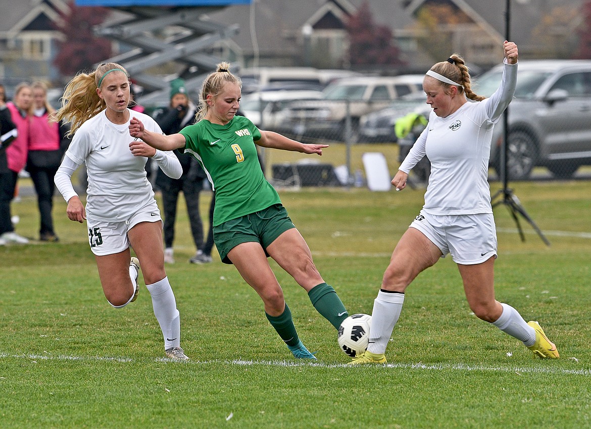 Whitefish's Delaney Smith tries to get past the Billings Central defenders in the State A championship on Saturday in Whitefish. (Whitney England/Whitefish Pilot)