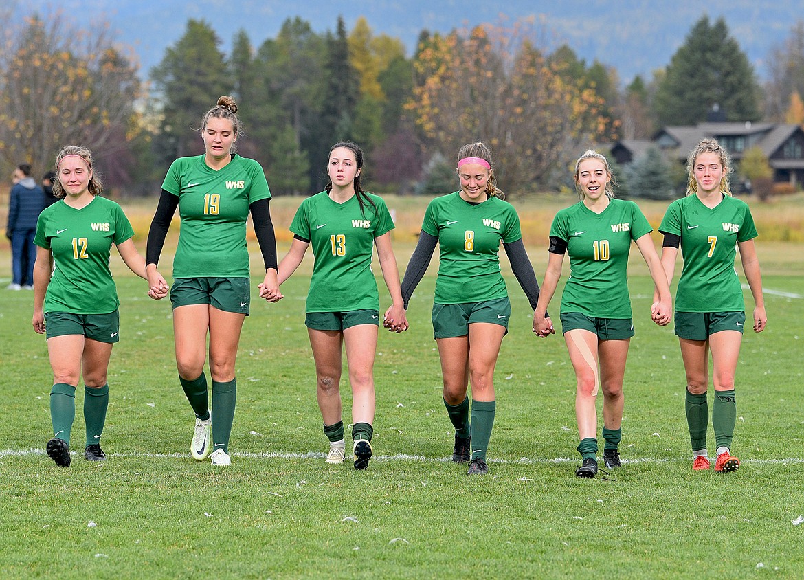 Whitefish seniors take a final walk across their home field after losing in the state championship game on Saturday in Whitefish. From left to right: Katie Benkelman, Rya Hirsch, Maya Lacey, Madelyn Alexander, Maddie Muhlfeld and Brooke Roberts. (Whitney England/Whitefish Pilot)