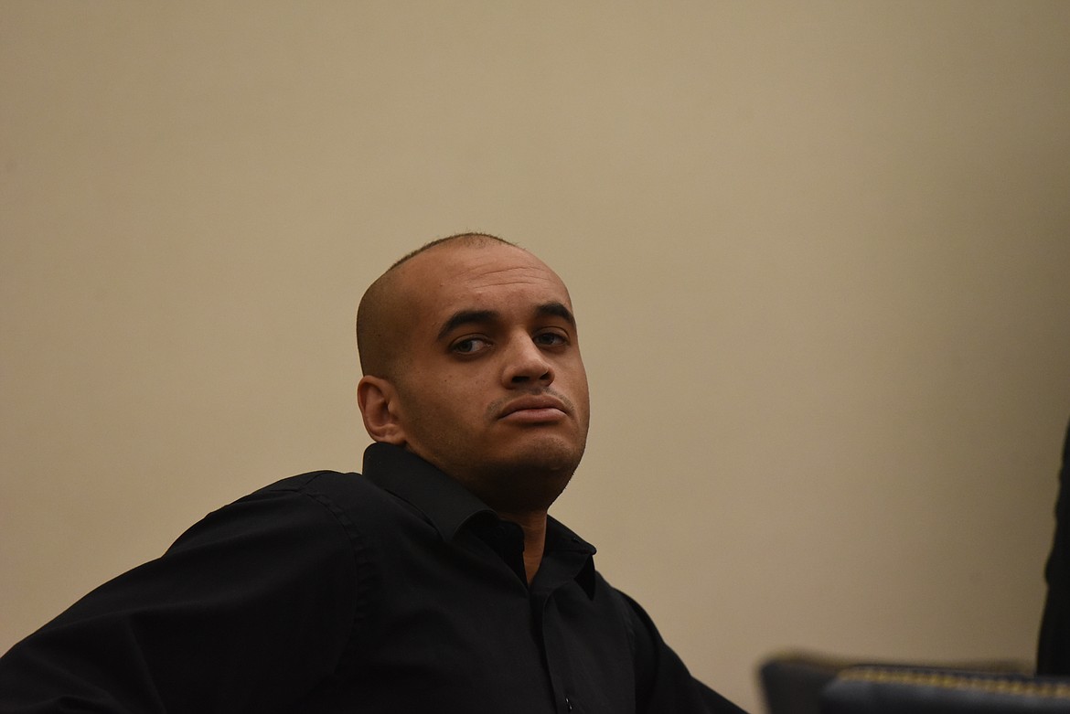 Romano Corbitt sits at the defendant's table in Flathead County District Court during his arraignment on an assault with a weapon charge. (Derrick Perkins/Daily Inter Lake)