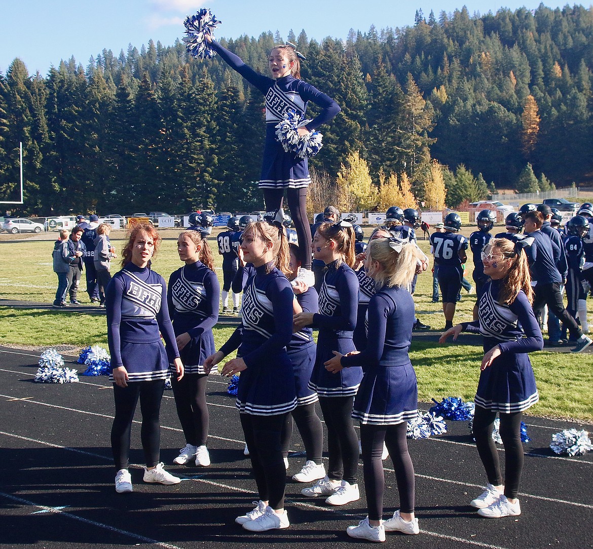 Badger cheer team keeping the crowd engaged at playoff game.