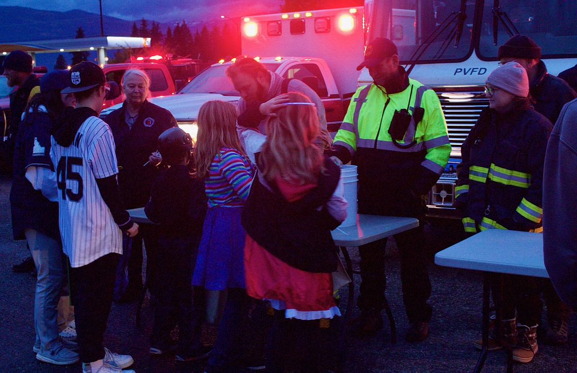 First responders handing out candy at the Glowing Treats trunk-or-treat at Boundary County Middle School parking lot on Oct. 31.