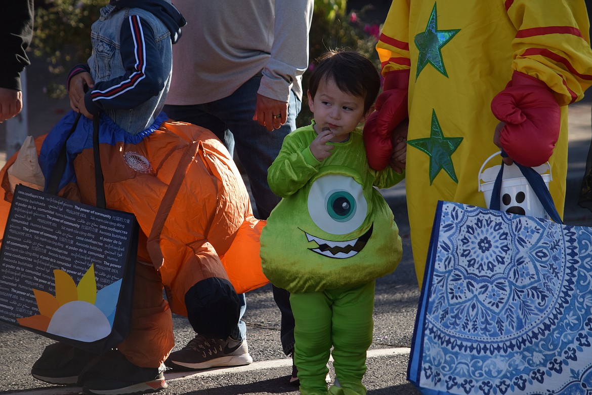 Jax Vela, dressed as monster Mike Wazowski from the movie Monsters, Inc., stands with his father Antonio during the Harvest Fair in Moses Lake on Saturday.