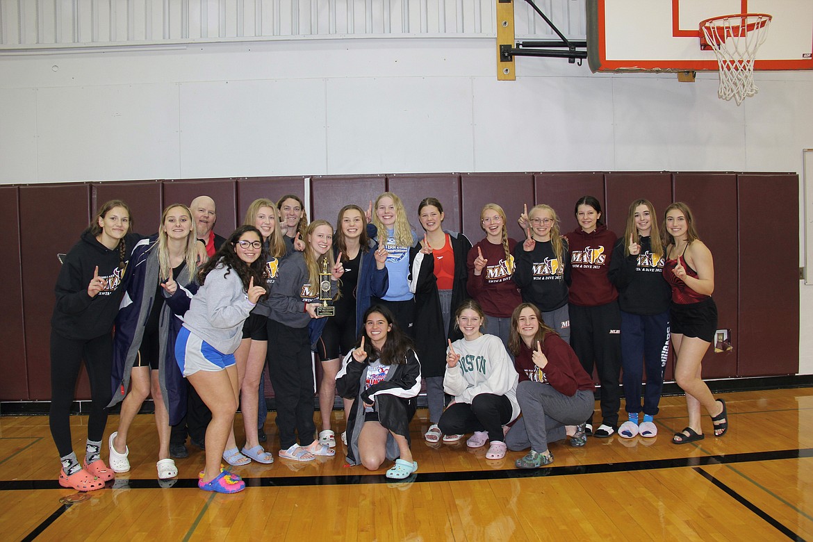 The Maverick girls swim and dive team poses with the district championship trophy.