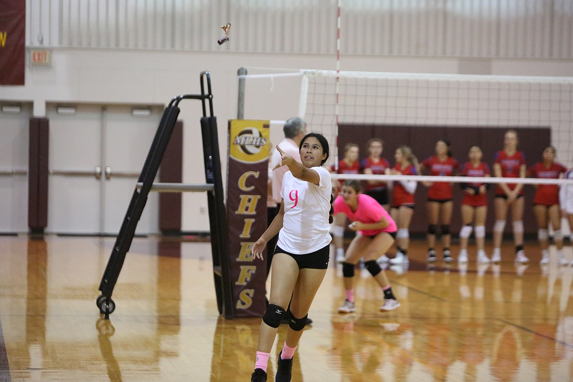 Jazlynn Torres tosses candy to the Moses Lake student section during player introductions for the Mavericks.