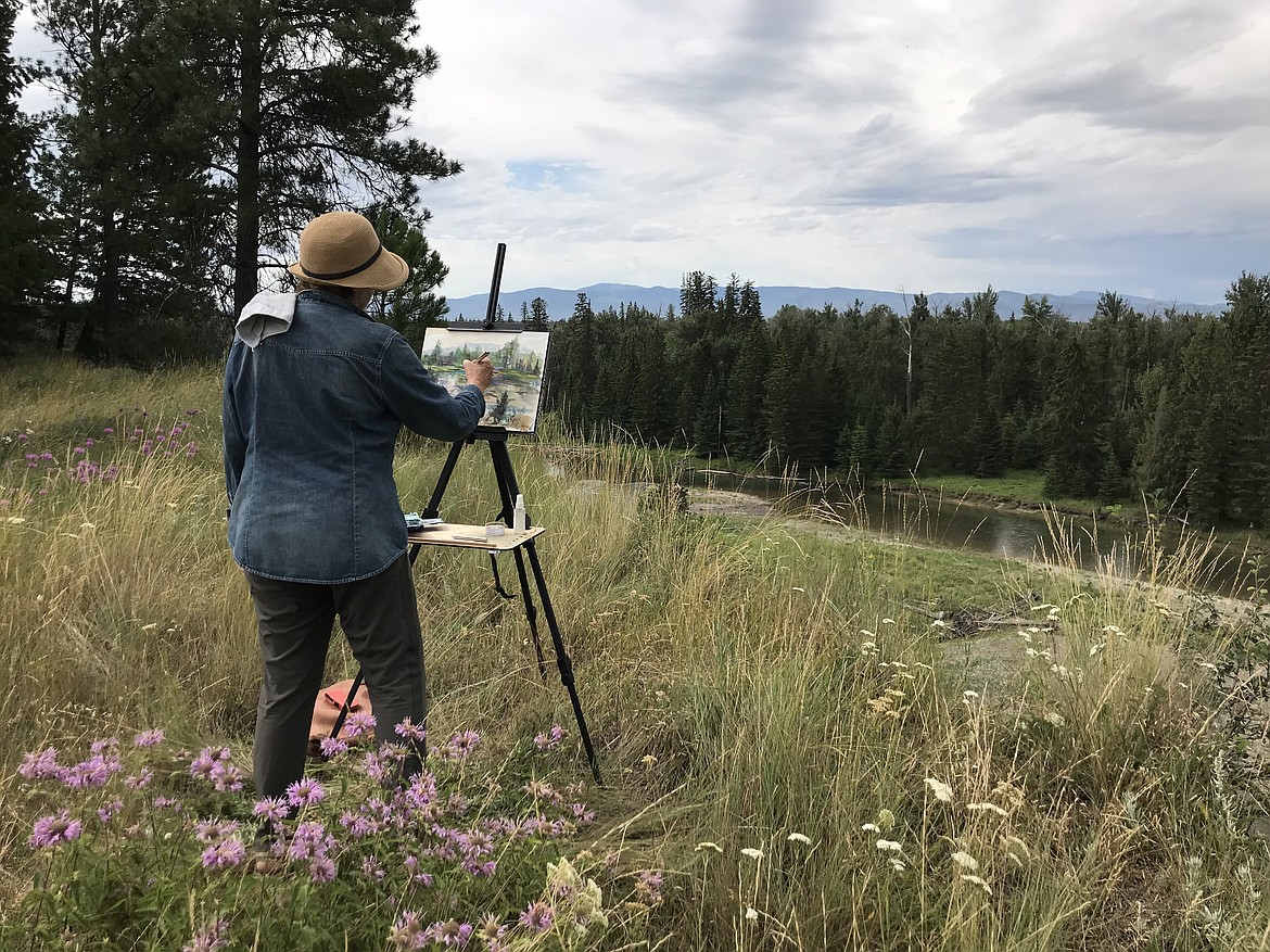 Wendy Hale painting the Flathead River for the Flathead River in Paint fundraising event