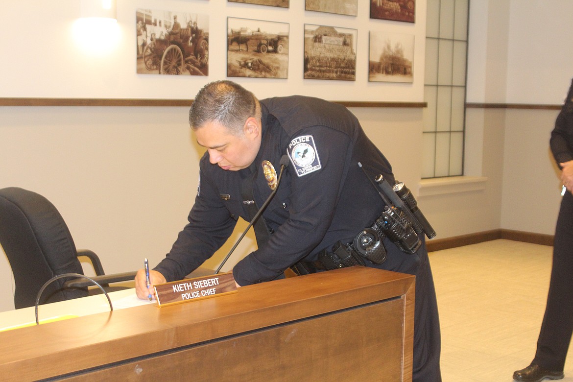 Quincy Police Department patrol officer Alan Talbot takes the oath of office during the Quincy City Council meeting Tuesday.