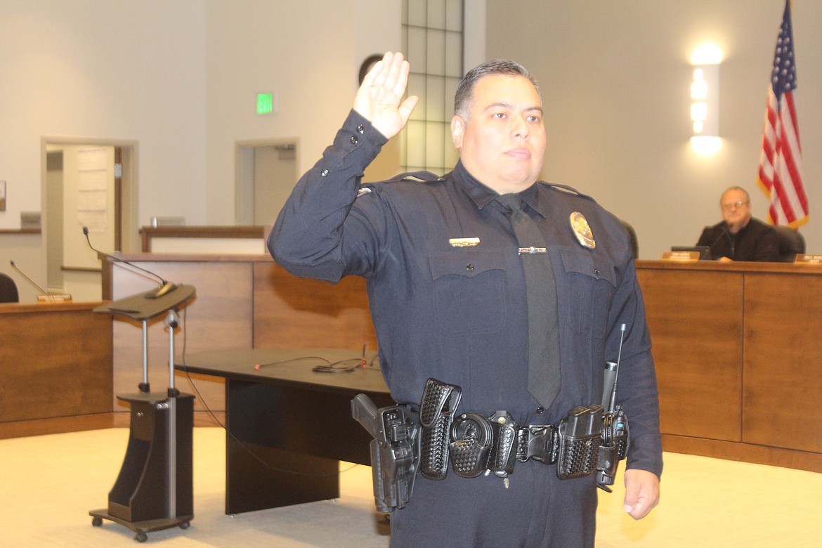 Quincy Police Department patrol officer Alan Talbot takes the oath of office during the Quincy City Council meeting Tuesday.