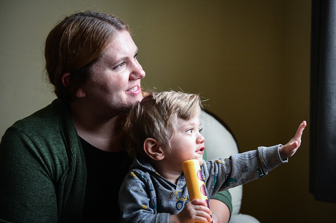 Breanna Villanueva and her son Rocky watch the snow fall from a window inside their home in Kalispell on Wednesday, Nov. 2. (Casey Kreider/Daily Inter Lake)