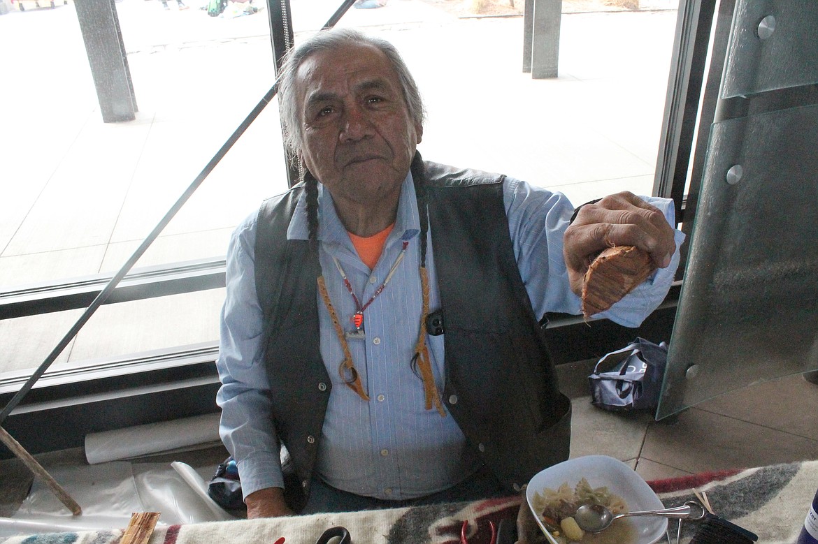 Yakama craftsman Lindsey Howtopat shows a cedar bark basket at Archaeology Days at the Wanapum Heritage Center. He’s tried different configurations, he said, but the traditional football-shaped bottom is most efficient for transporting huckleberries.